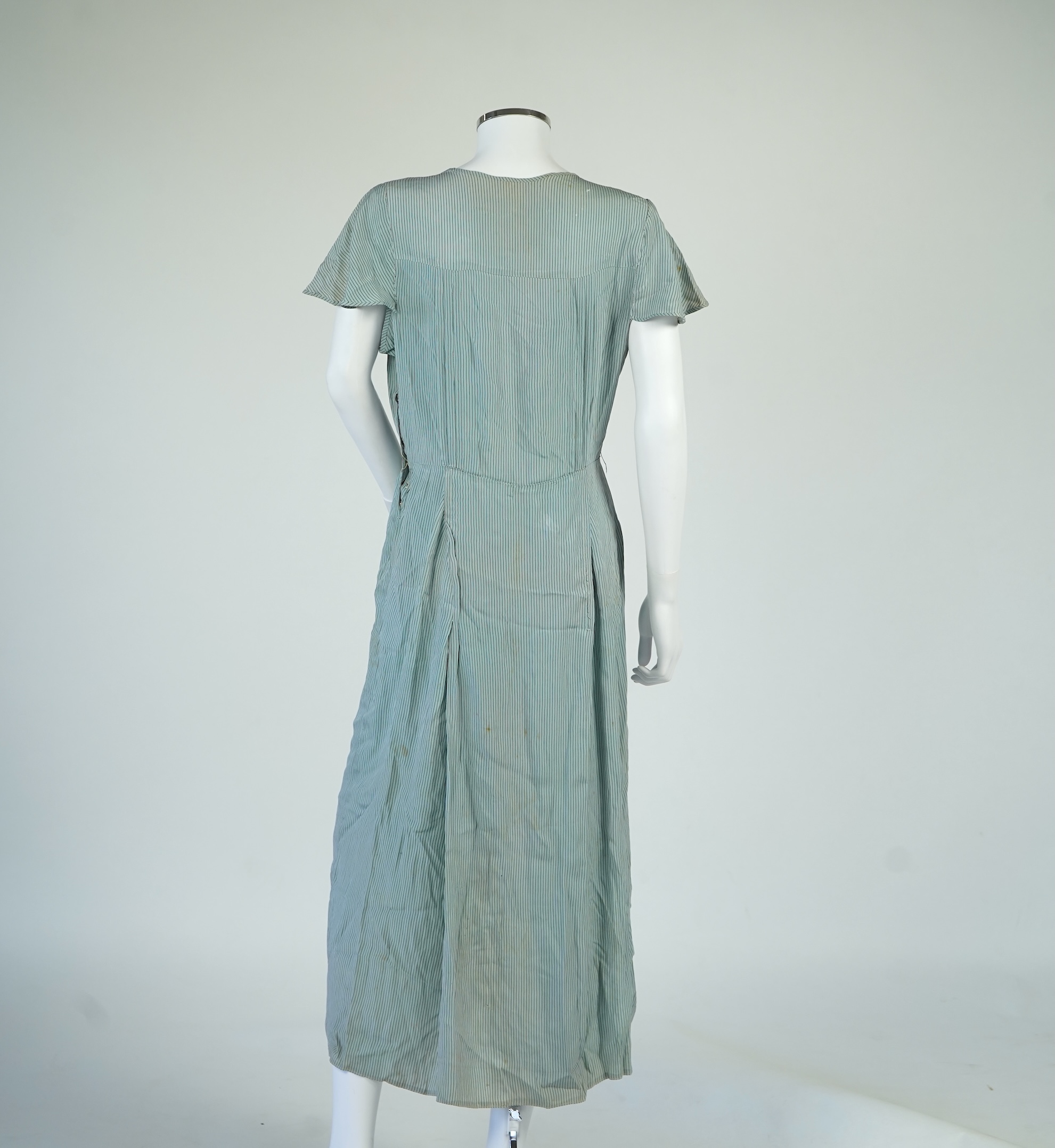 Two 1930's printed silk crepe summer day dresses together with a similar pale blue and black stripped summer day dress., Condition - the maroon and cream dress has damage to one sleeve, the green dress has worn under the